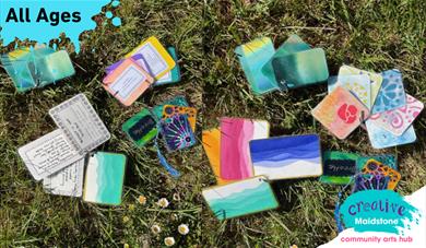 Colourful index cards sitting on a grassy background with 18+ on a paint splat in the top left corner