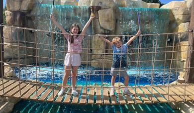 Bridge over the Waterfall and two children