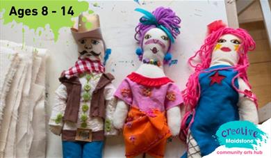 Three handmade fashion dolls on a work bench