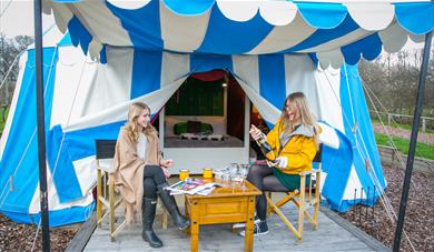 Friends outside glamping tent at Leeds Castle Knight's Glamping