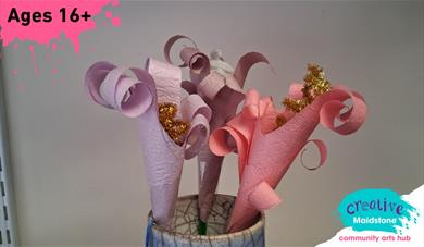 Three lilies made of paper in a vase