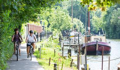 Two cyclists on path next to the River Medway