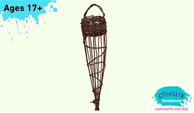 A woven willow bird feeder on a yellow background