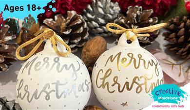 Christmas baubles with calligraphy writing on