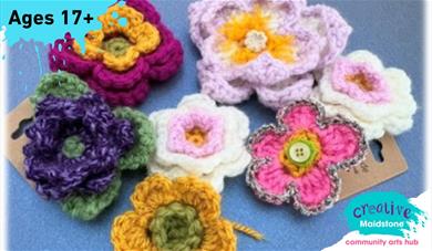 Selection of crocheted flowers on a blue background