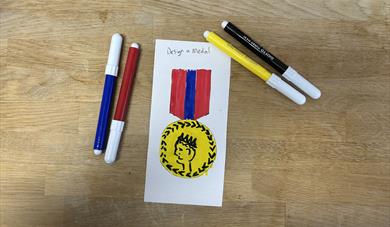 felt pens and a drawing of a medal