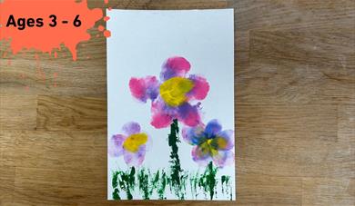 Ages 3 - 6 on a paint splat in the top left corner. main image a simple painting made with 3 flowers
