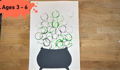 Paint splat with ages 3 - 6. Main image a Cauldron with green and purple Bubble Painted bubbles coming out of the top
