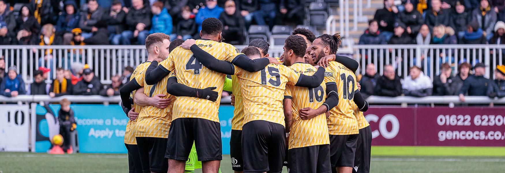 Maidstone United footballers in a huddle