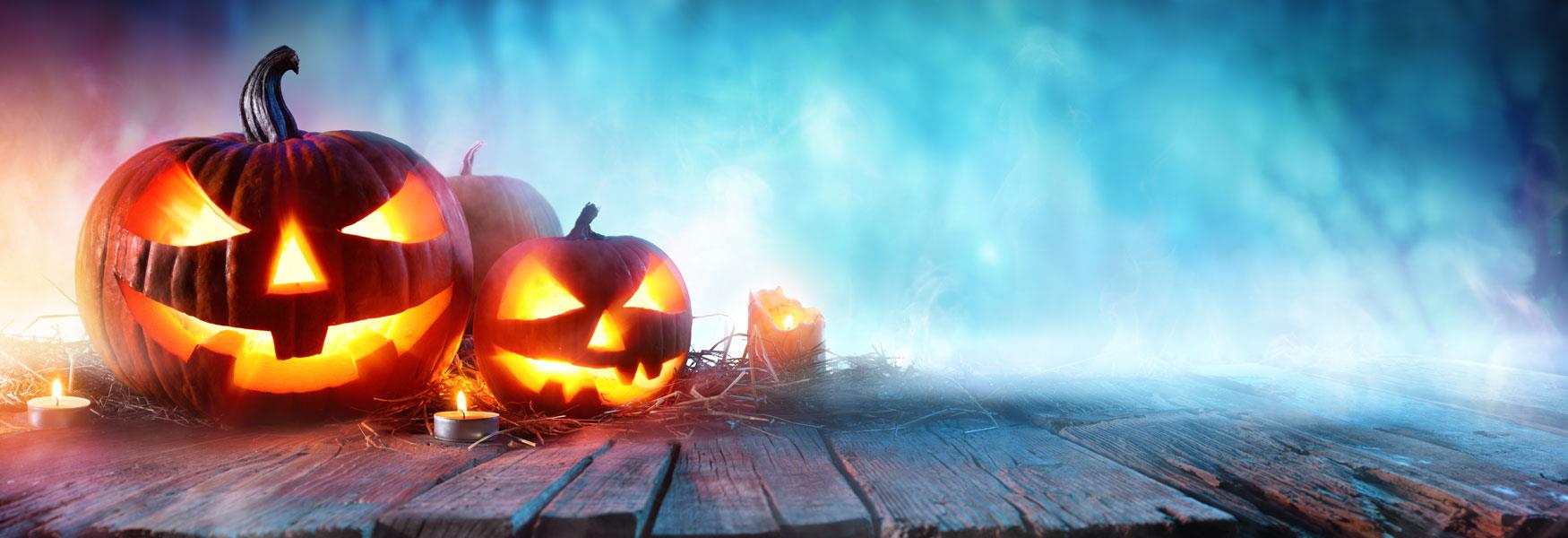 Spooky Halloween pumpkins, with candles lighting their faces from the inside.