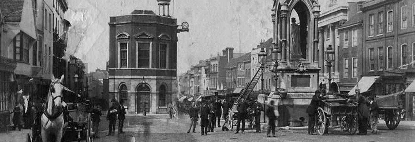 Old photo of horse drawn vehicles in the Upper High Street or High Town, now known as Jubilee Square