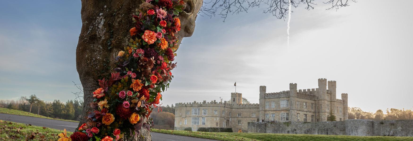 Decorated tree for Halloween with Leeds Castle in the backgound.
