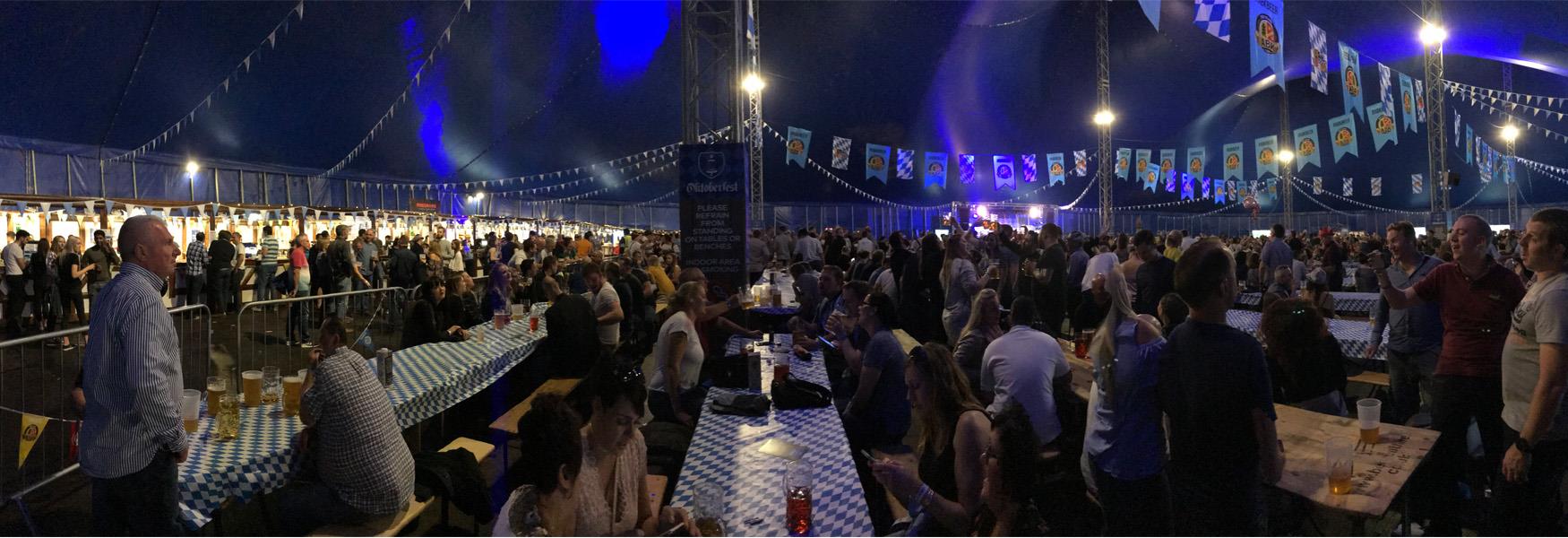 Crowds having fun at the Bavarian Beer Festival in Mote Park called Oktoberfest.  There's a lot of singing.