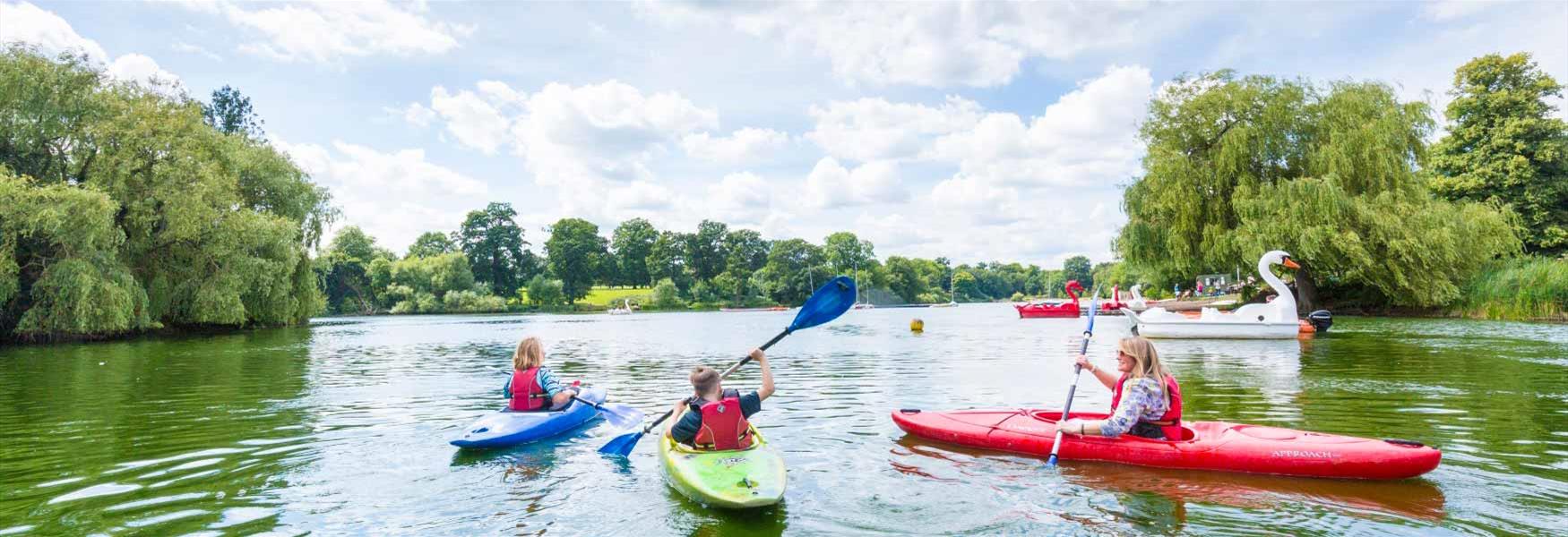 Family canoeing on lake at Mote Park