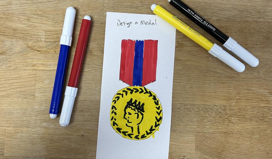 felt pens and a drawing of a medal