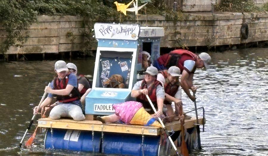 A raft made of oil cartons with people paddling