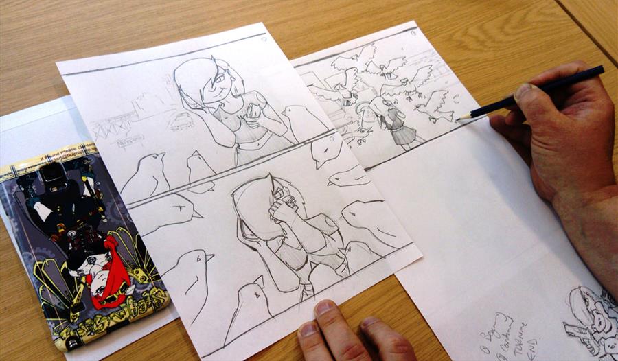 A birds eye view of someone drawing in the style of manga.