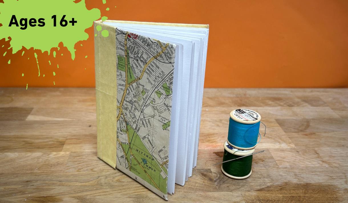 Paint splat with the words Ages 16+ main image a book with 2 cotton reel next to it