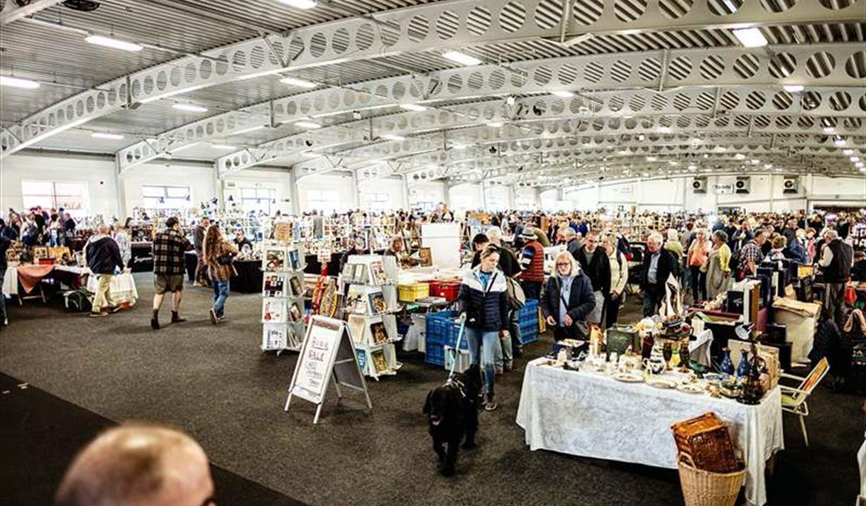 Exhibition hall full of stalls and people browsing