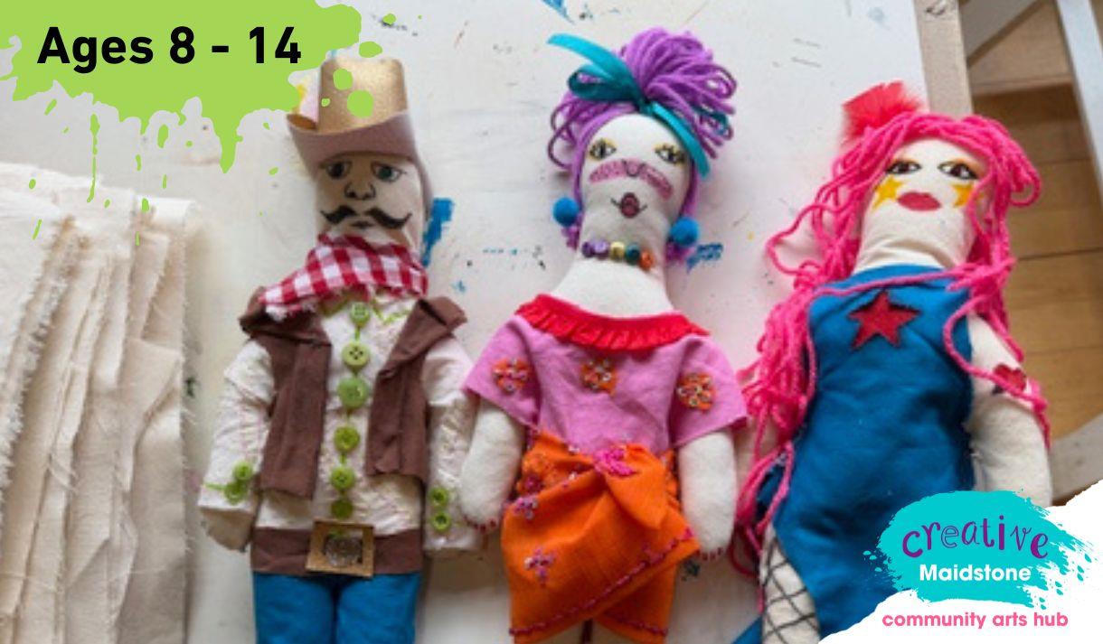 Three handmade fashion dolls on a work bench