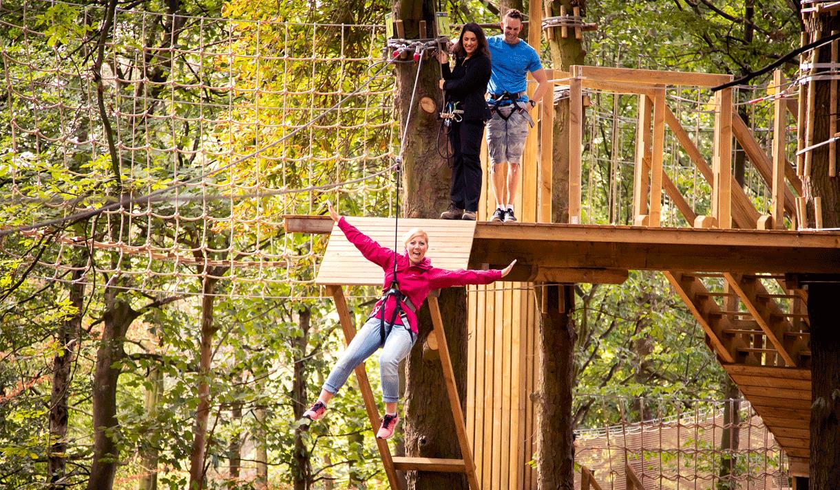 Woman enjoying Go Ape in harness