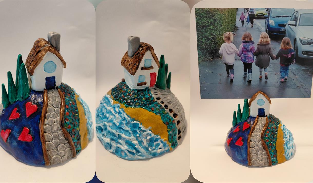 Pictures of three little painted clay houses