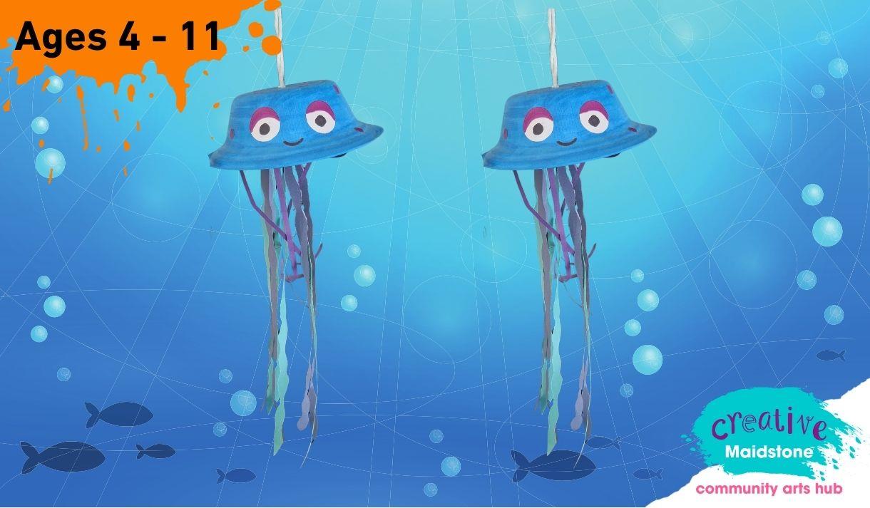 Two jellyfish made of paper plates on an underwater background with fish