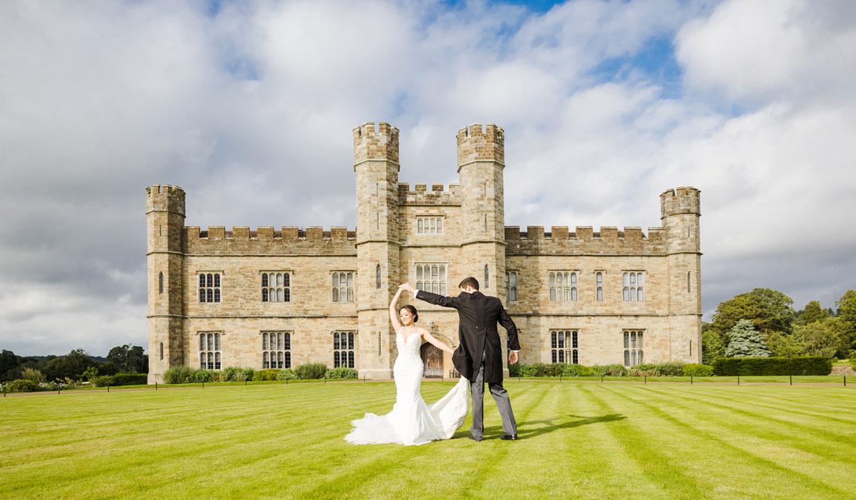 Wedding couple on the croquet lawn outside Leeds Castle