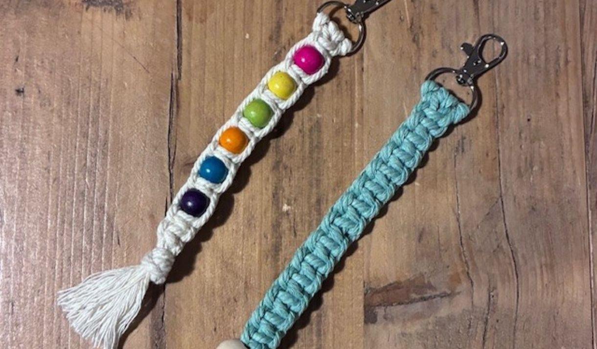 Two macrame keychains. One green colour and the other with colourful beads