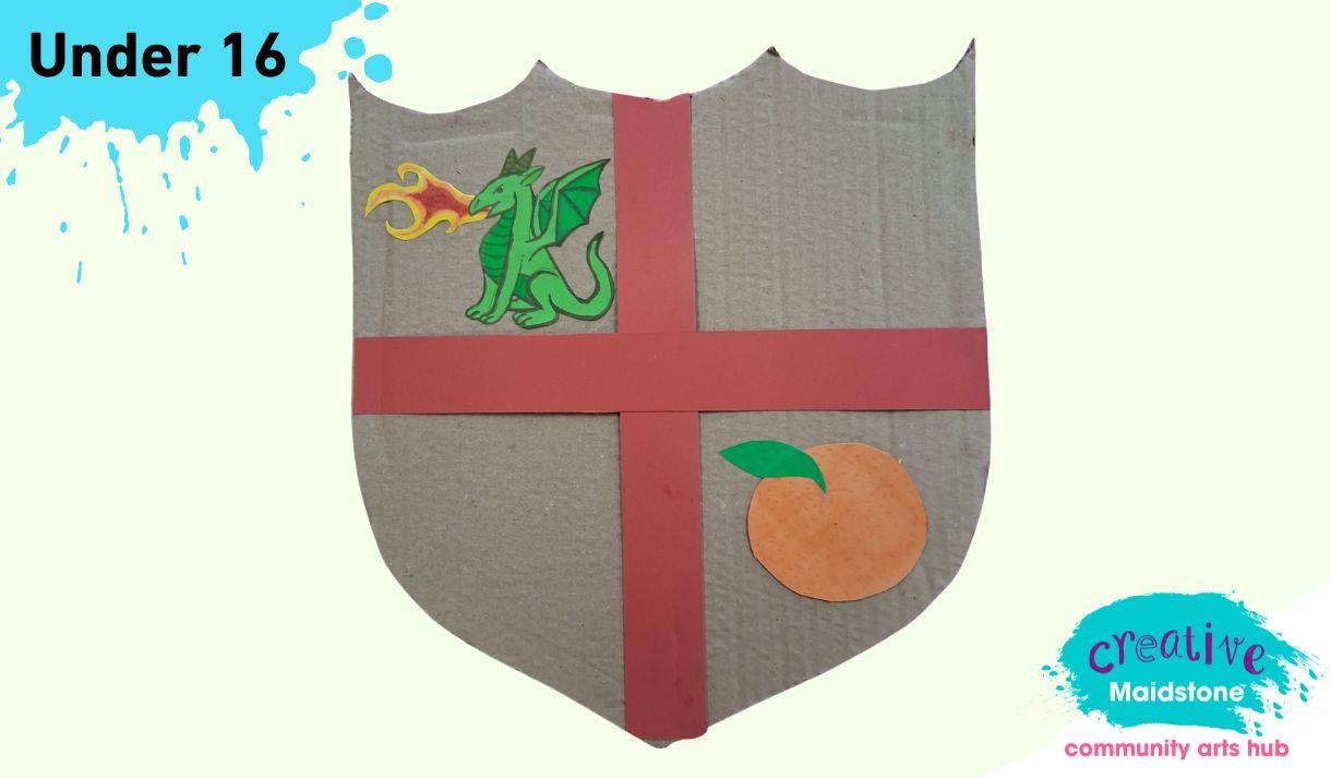A cardboard St George's Shield on a yellow background