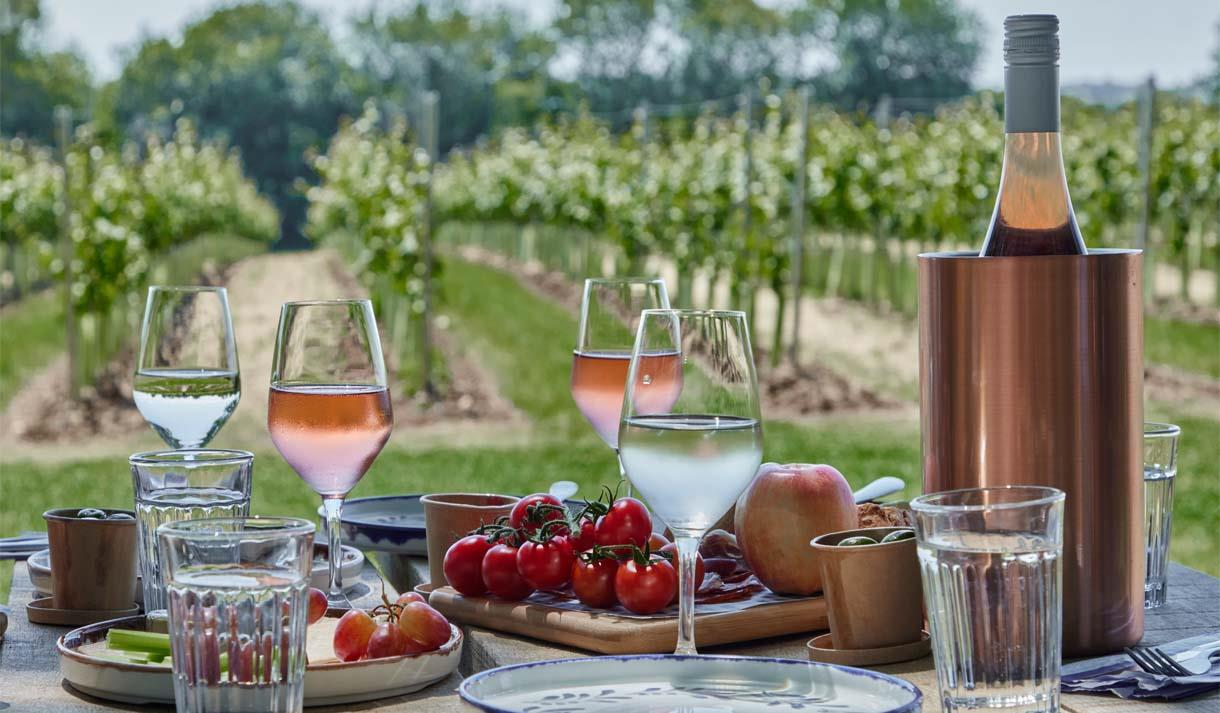 Glasses of wine on a table overlooking the vineyard