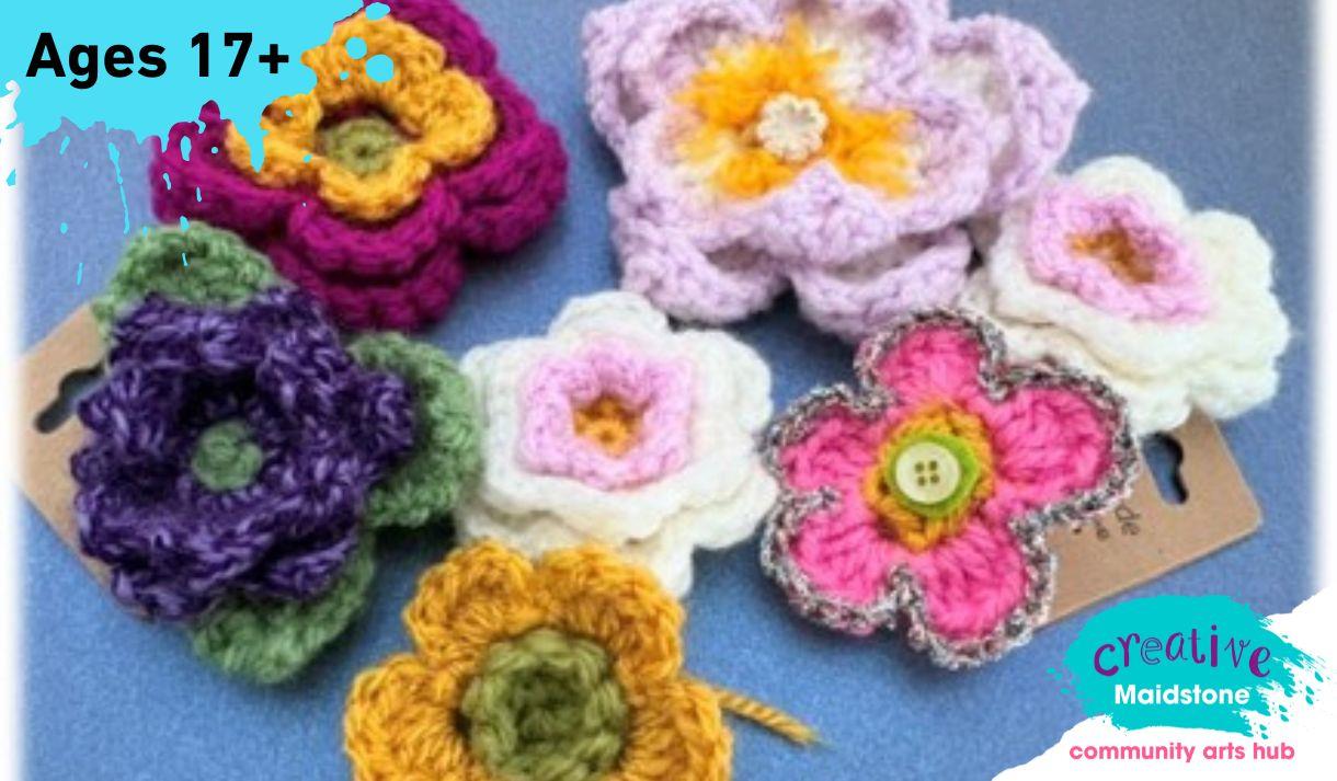 Selection of crocheted flowers on a blue background