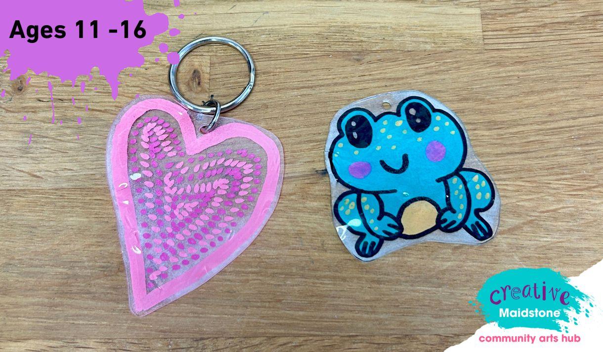 A pink heart keyring and a hand drawn frog keyring