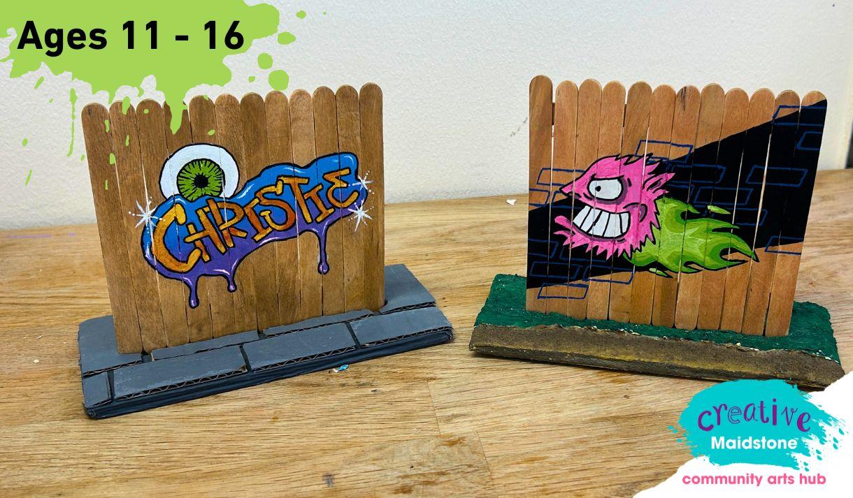 Miniature fences made out of lollipops decorated with street art designs