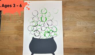 Paint splat with ages 3 - 6. Main image a Cauldron with green and purple Bubble Painted bubbles coming out of the top