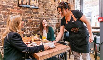 Two ladies getting coffee in Puddings