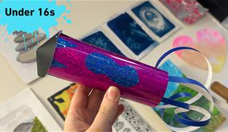 Paint splat with Under 16s and a paper rocket with shiny paper