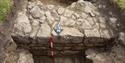 Archaeological excavation showing a revealed stone feature