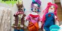 Three handmade fashion dolls on a work bench