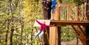 Woman enjoying Go Ape in harness