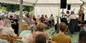 Audience listening to music in a marquee