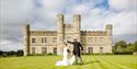 Wedding couple on the croquet lawn outside Leeds Castle