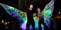 Stilt walkers with light up wings for Light Up festival