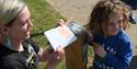 Child enjoying the wax rubbings on the plaque