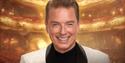 John Barrowman in a white suite smiling. Title text says John Barrowman My Life In Musicals