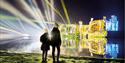 Children looking at Leeds Castle illuminated for Christmas