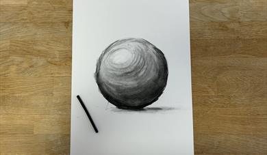 a drawing of a ball done in charcoal
