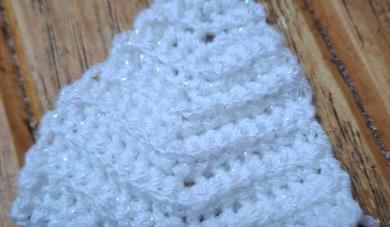 White sparkly Christmas tree made out of crochet