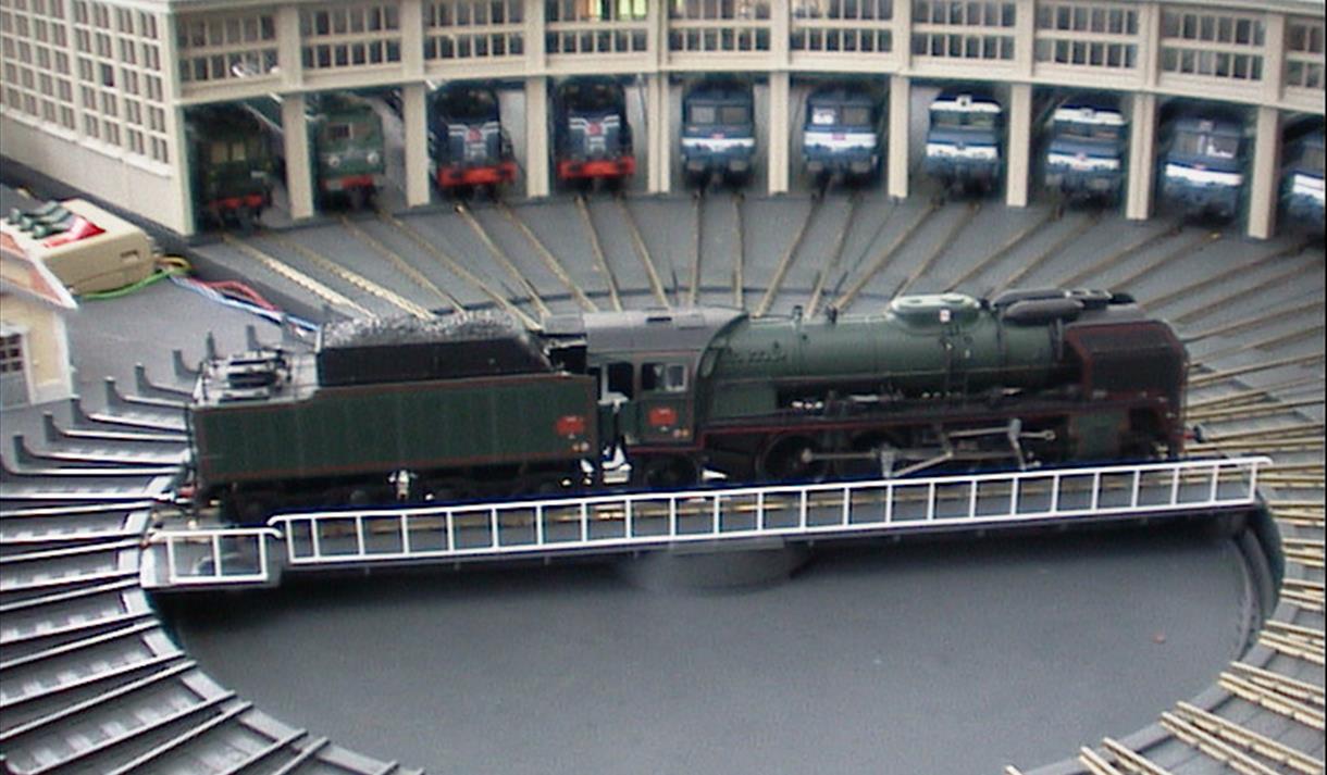 Model train turntable and locomotive sheds