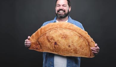 Charlie Baker holding a Pasty